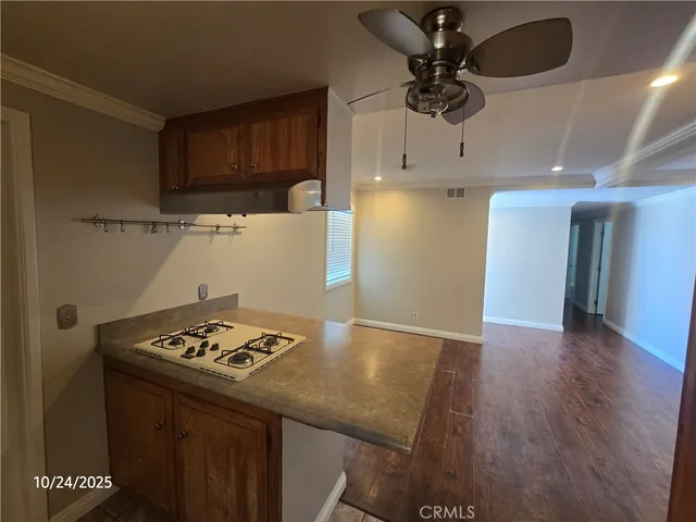 a kitchen with stainless steel appliances granite countertop a sink a stove and a refrigerator