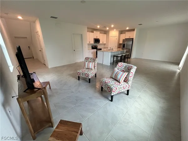 a living room with furniture and kitchen view