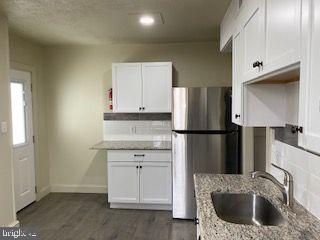 278 A Newtown Road Warminster, PA 18974 - Photo 3 of 21 a kitchen with a refrigerator sink and cabinets