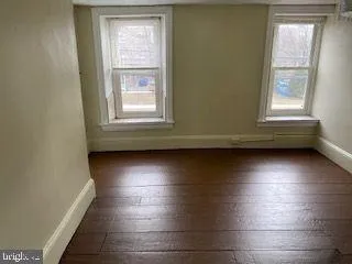 a view of wooden floor and windows in a room