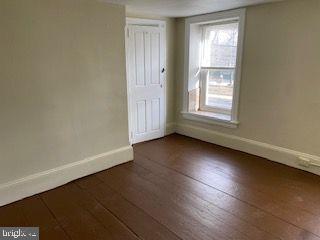 278 A Newtown Road Warminster, PA 18974 - Photo 7 of 21 an empty room with wooden floor and windows