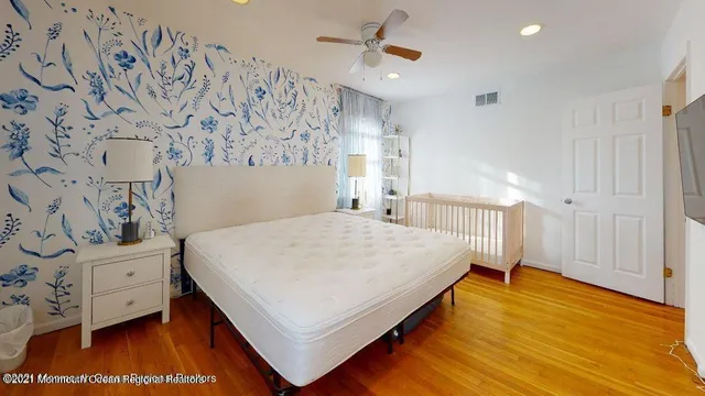 a spacious bedroom with a bed and a window