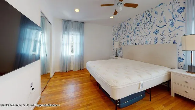 a bedroom with a bed and a chandelier