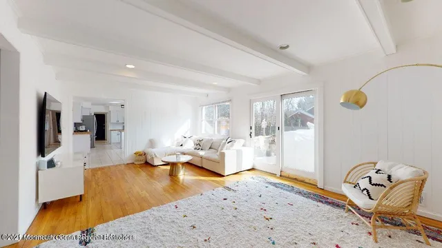 a living room with furniture and flat screen tv