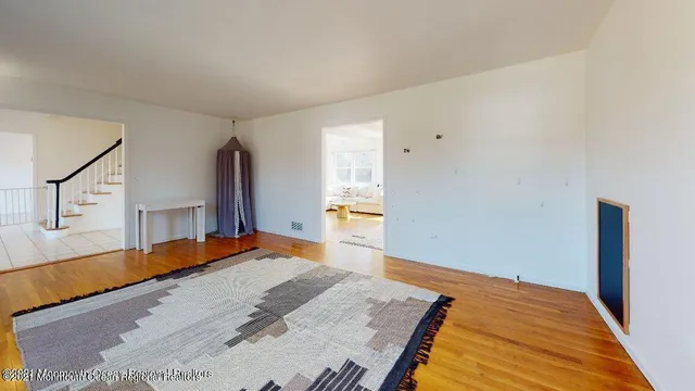 a bedroom with a bed and a large mirror on the dresser