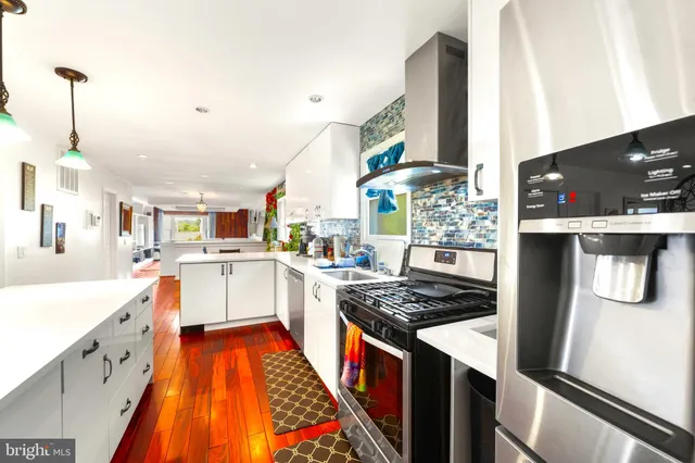 a kitchen with stainless steel appliances granite countertop a sink and a stove
