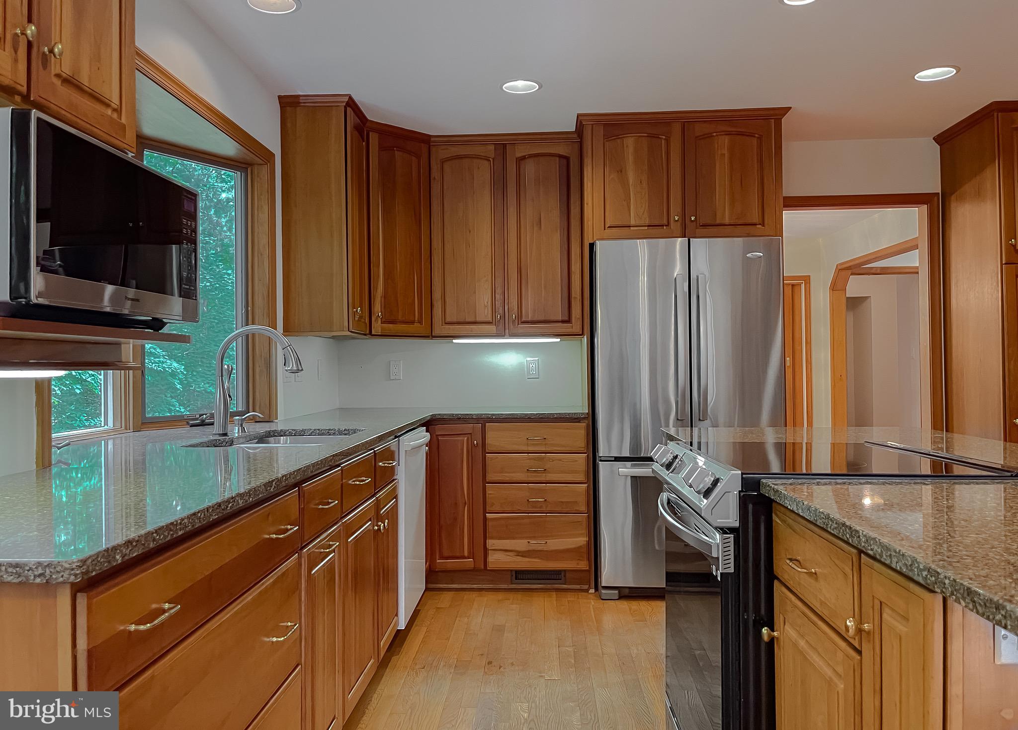 3050 Ross Road St. Leonard, MD 20685 - Photo 27 of 87 a kitchen with stainless steel appliances granite countertop a refrigerator and a sink