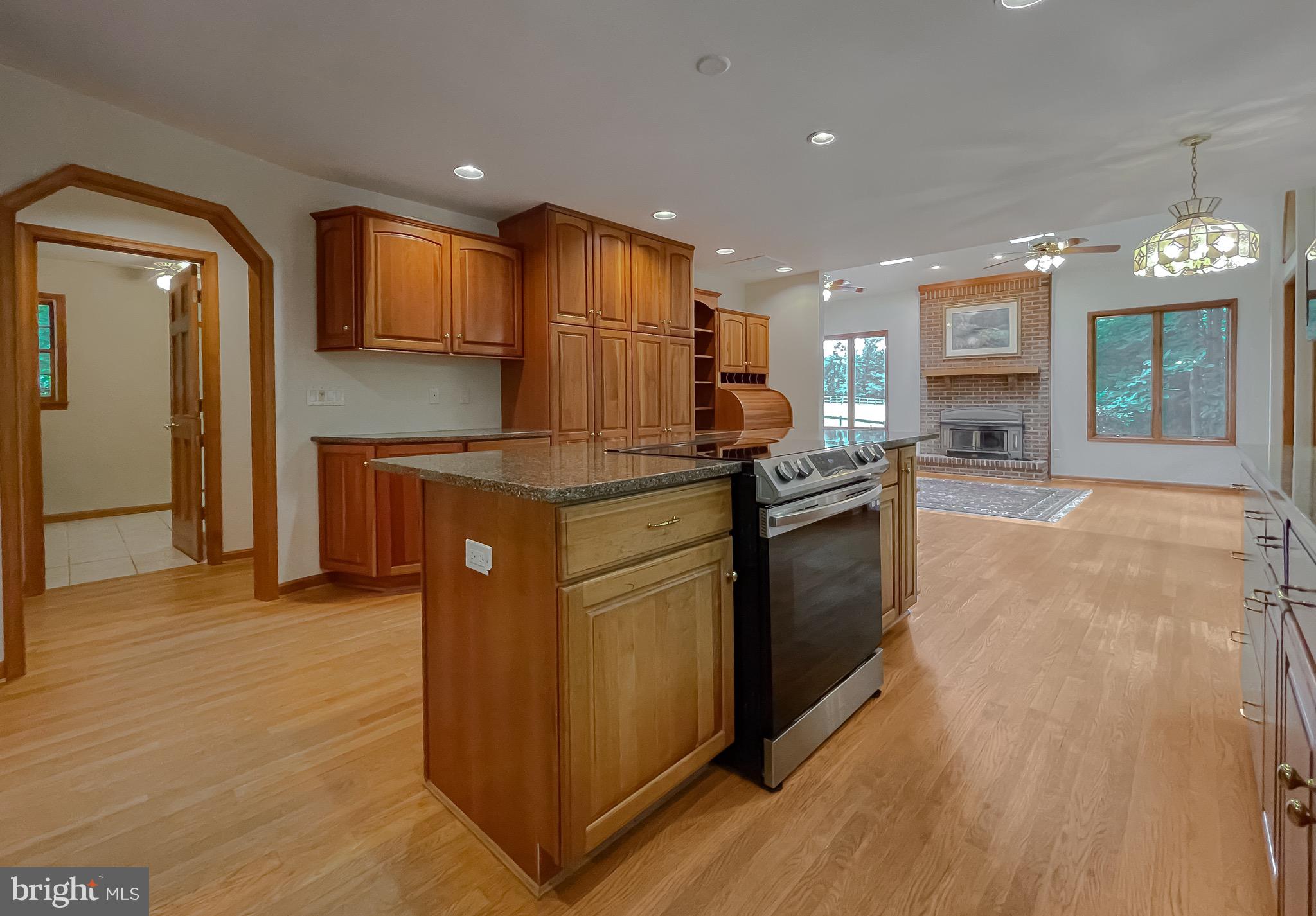 3050 Ross Road St. Leonard, MD 20685 - Photo 30 of 87 a kitchen with stainless steel appliances granite countertop a refrigerator a stove and a wooden floors