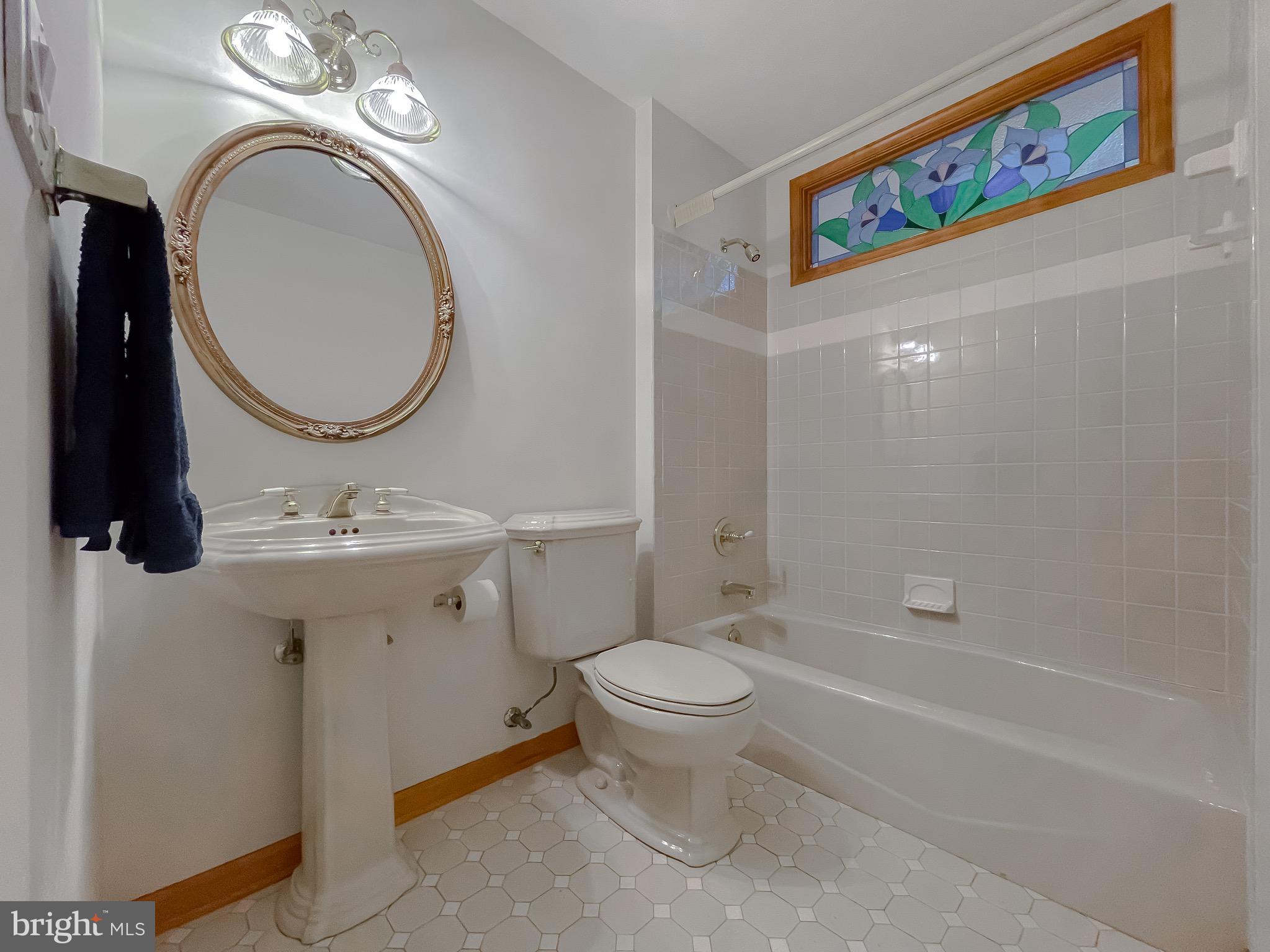 3050 Ross Road St. Leonard, MD 20685 - Photo 33 of 87 a bathroom with a toilet sink and mirror