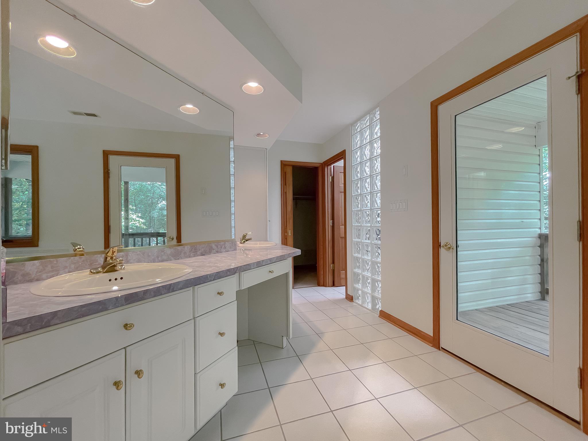 3050 Ross Road St. Leonard, MD 20685 - Photo 42 of 87 a spacious bathroom with a granite countertop sink a mirror and a