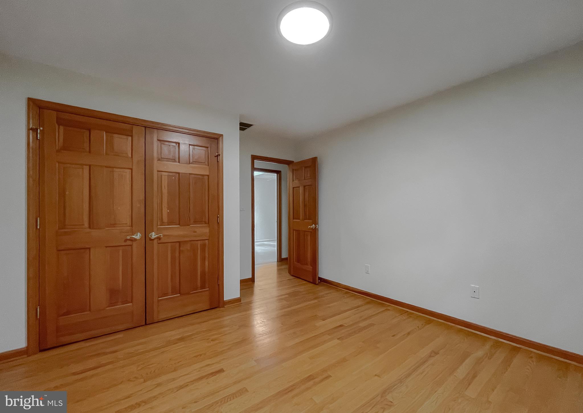 3050 Ross Road St. Leonard, MD 20685 - Photo 54 of 87 a view of an empty room with wooden floor