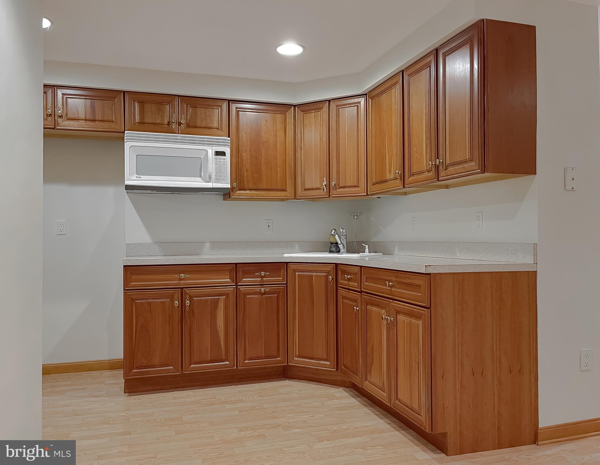 3050 Ross Road St. Leonard, MD 20685 - Photo 59 of 87 a kitchen with stainless steel appliances granite countertop wooden cabinets a sink and dishwasher