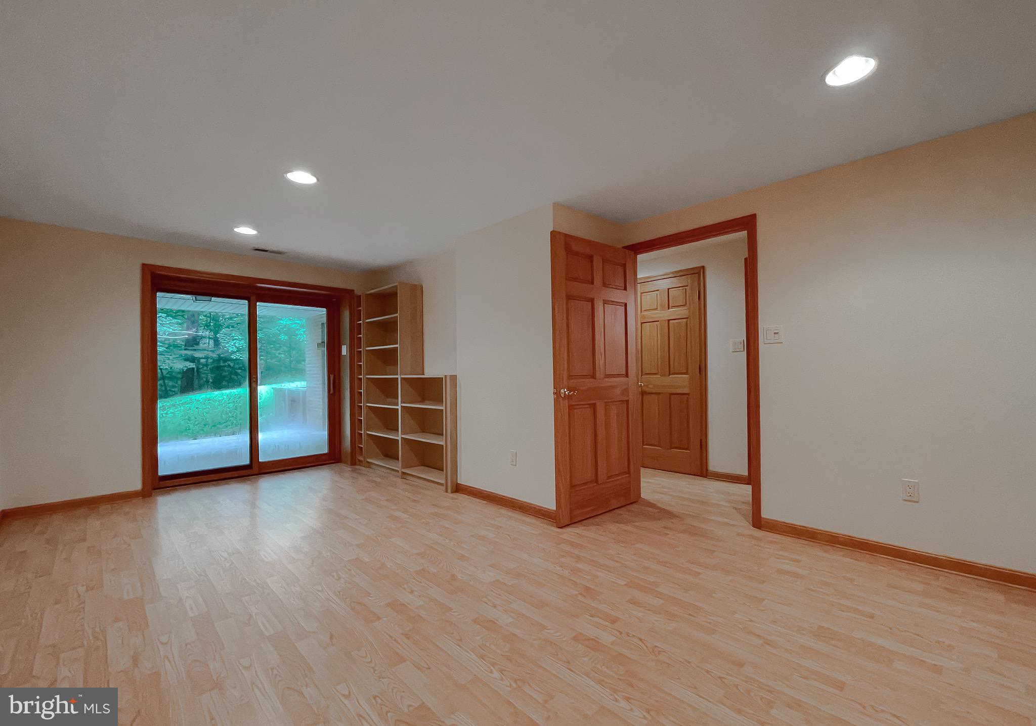 3050 Ross Road St. Leonard, MD 20685 - Photo 61 of 87 a view of an empty room with wooden floor and a window