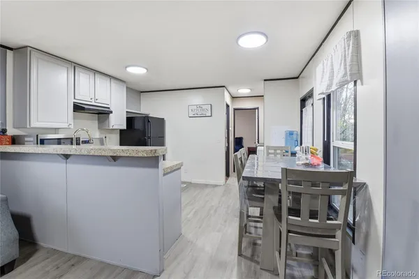a kitchen with cabinets and chairs
