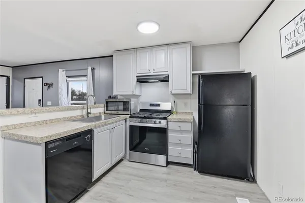 a kitchen with stainless steel appliances granite countertop a refrigerator and a stove