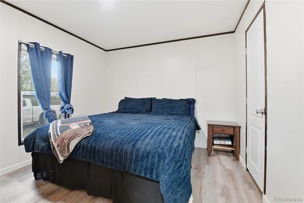 a bedroom with a bed and a mirror