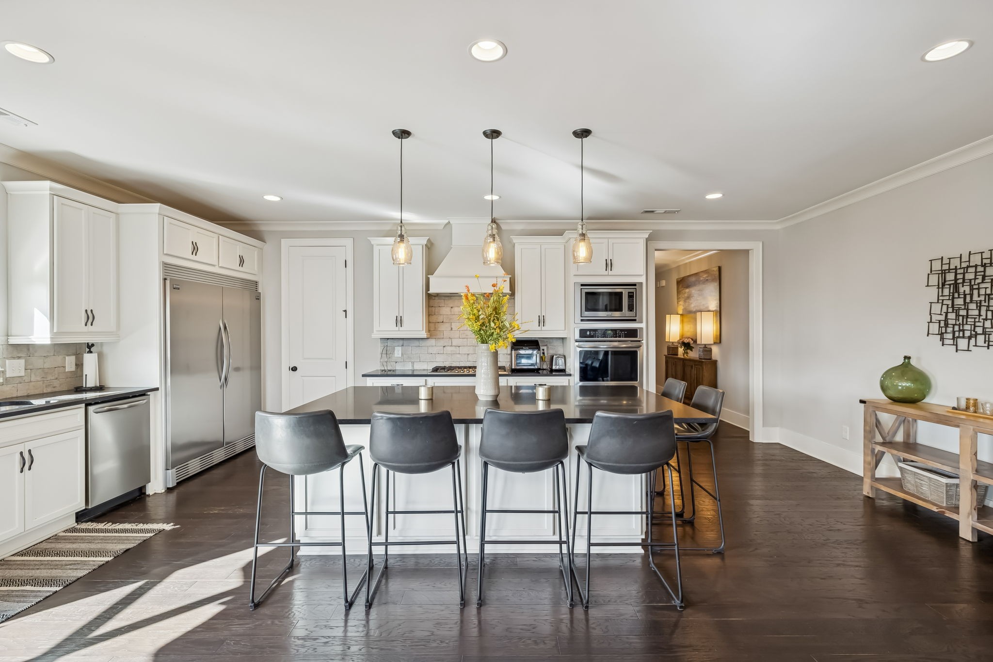142 Vanner Road Mount Juliet, TN 37122 - Photo 14 of 52 a kitchen with stainless steel appliances kitchen island granite countertop a table chairs stove and white cabinets