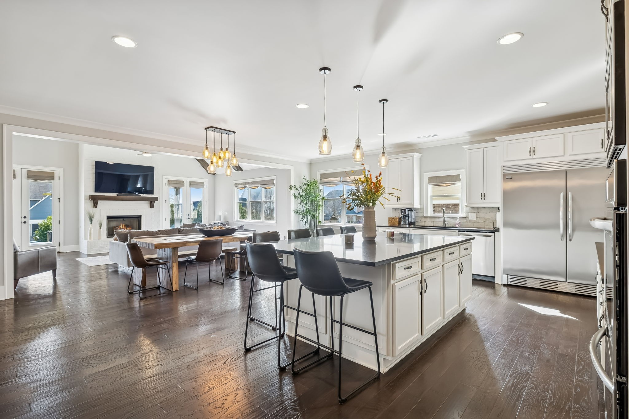 142 Vanner Road Mount Juliet, TN 37122 - Photo 19 of 52 a kitchen with stainless steel appliances granite countertop a stove top oven a sink dishwasher a dining table and chairs with wooden floor
