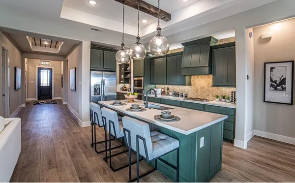 a kitchen that has a table chairs and wooden floor