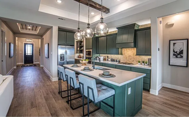 a kitchen that has a table chairs and wooden floor