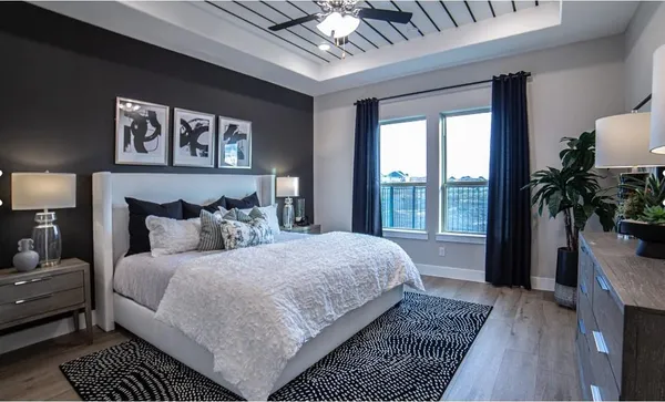 a bedroom with a large bed a rug and a window