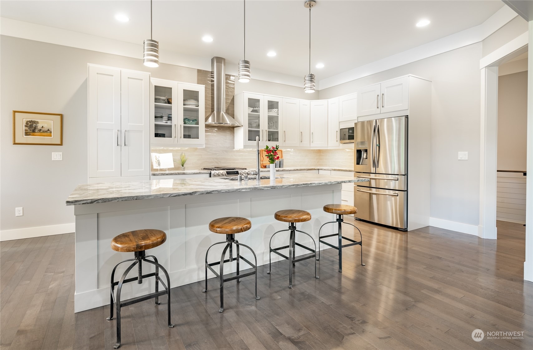 5433 Canvasback Road Blaine, WA 98230 - Photo 8 of 34 a kitchen with stainless steel appliances kitchen island granite countertop a dining table chairs and sink