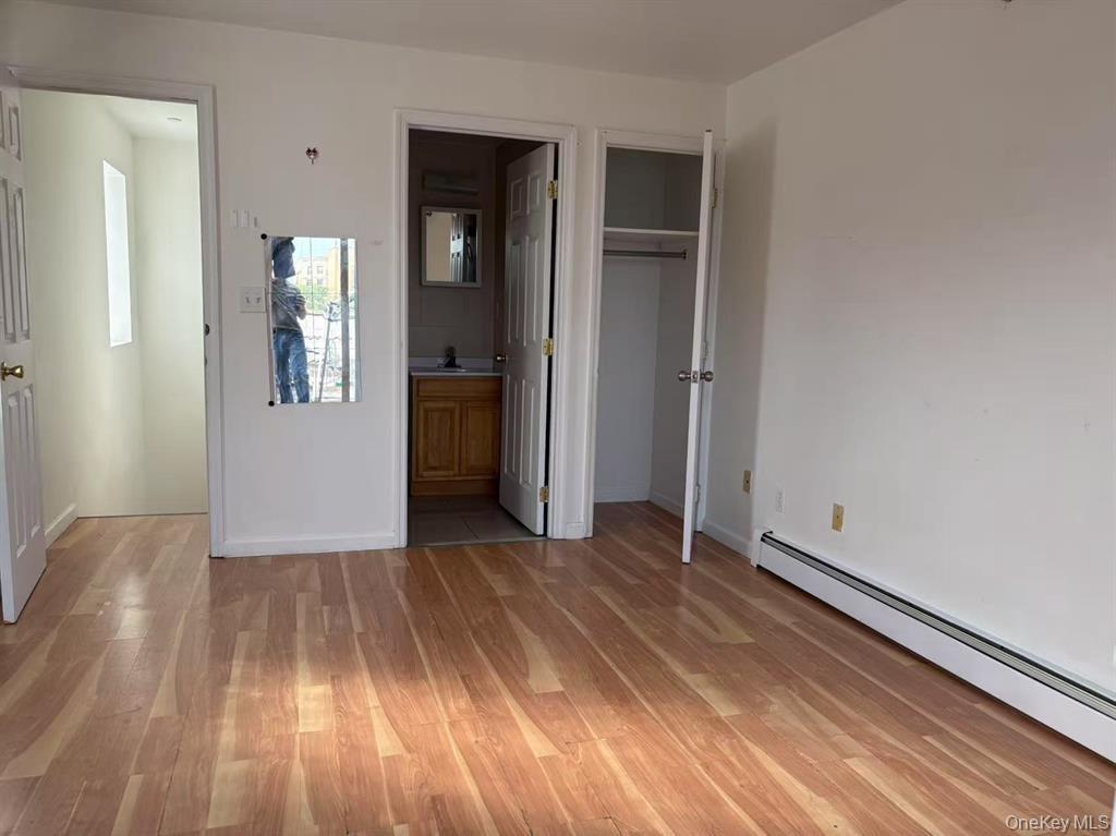132-73 Maple Avenue, Unit 4A Queens, NY 11355 - Photo 8 of 10 wooden floor in an empty room