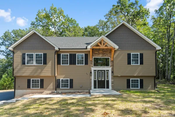 a house that has a tree in front of it