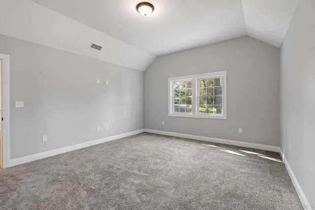 a view of a hallway with windows and stairs