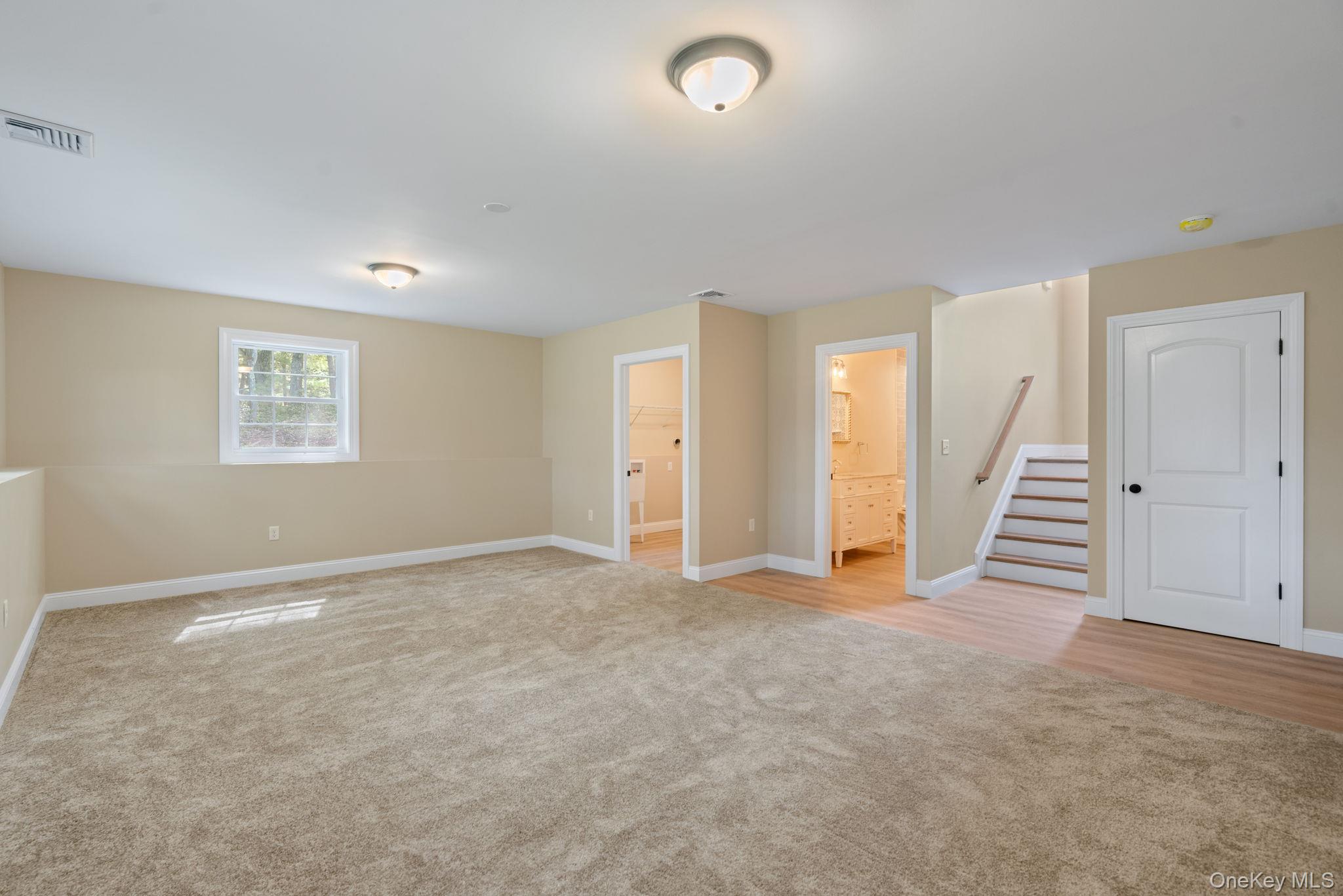 61 Smith Avenue Walden, NY 12586 - Photo 33 of 42 an empty room with a staircase and a ceiling fan