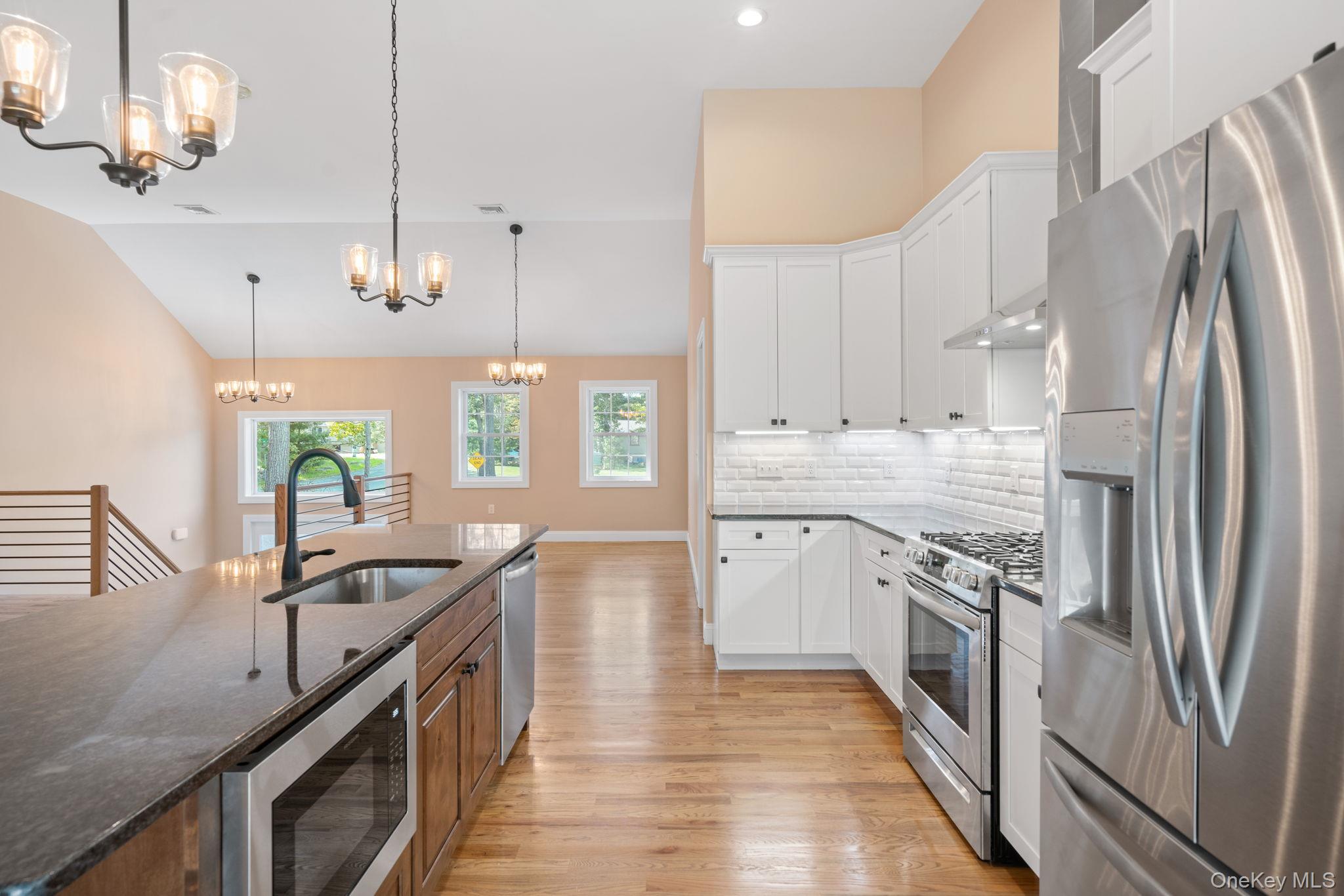 61 Smith Avenue Walden, NY 12586 - Photo 5 of 42 a kitchen with stainless steel appliances granite countertop a sink a stove and a refrigerator