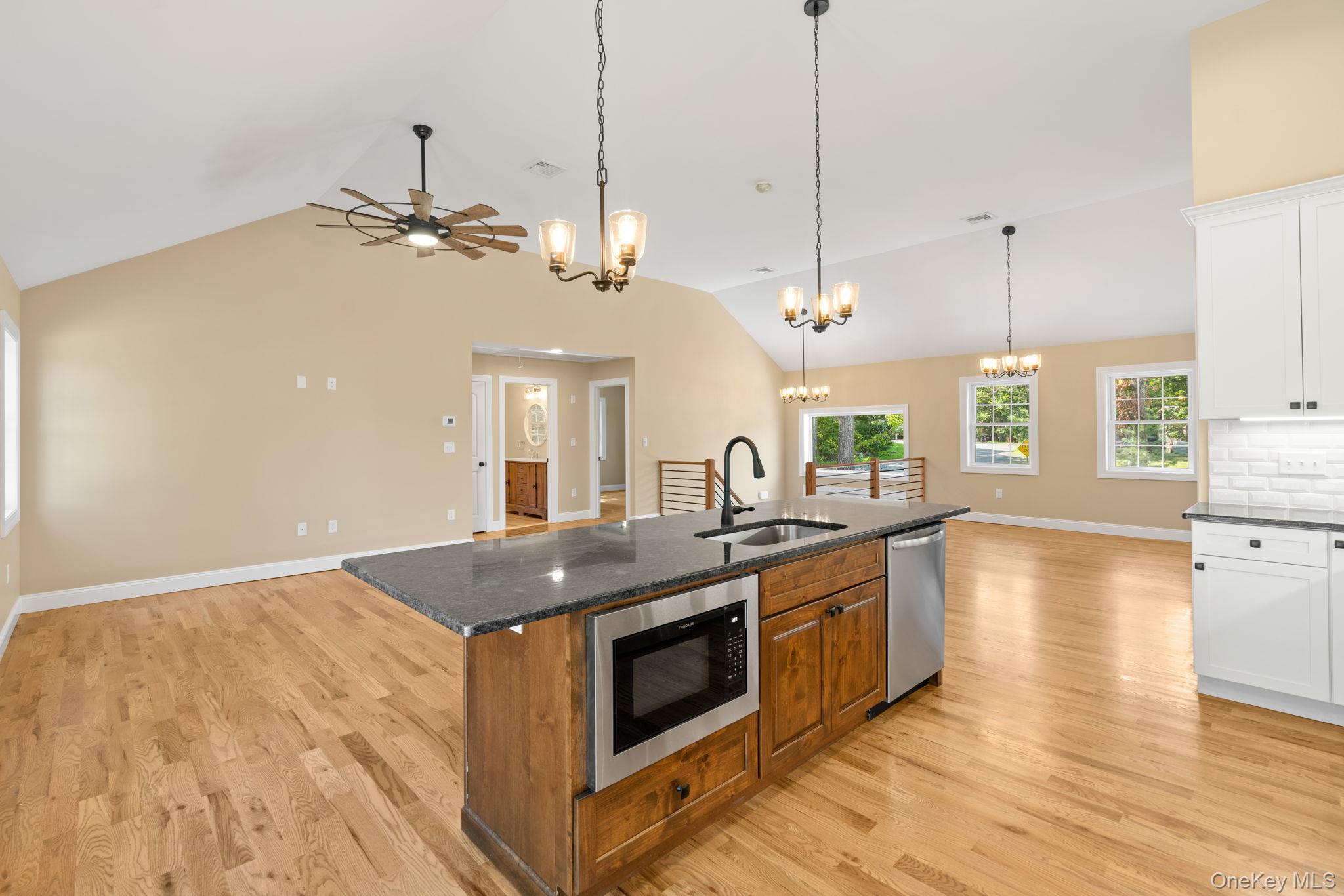 61 Smith Avenue Walden, NY 12586 - Photo 41 of 42 a kitchen with stainless steel appliances granite countertop a stove a sink and a wooden floor