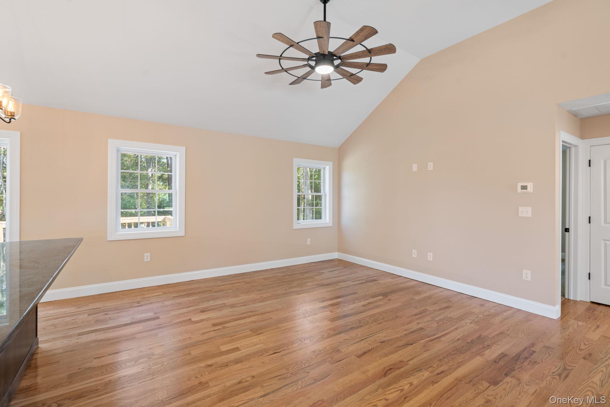 61 Smith Avenue Walden, NY 12586 - Photo 8 of 42 an empty room with wooden floor chandelier fan and windows