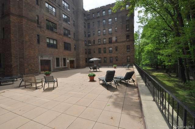 143 Garth Road, Unit 5J Scarsdale, NY 10583 - Photo 34 of 47 a view of outdoor space with seating area and trees