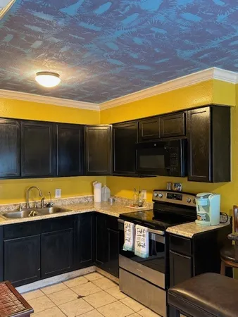 a kitchen with a sink and cabinets