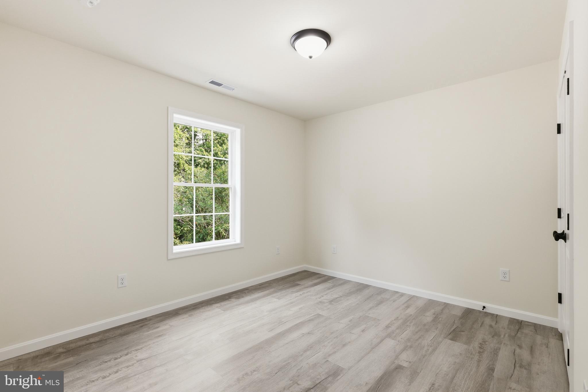 1354 College Road Dover, DE 19904 - Photo 32 of 46 an empty room with wooden floor and windows