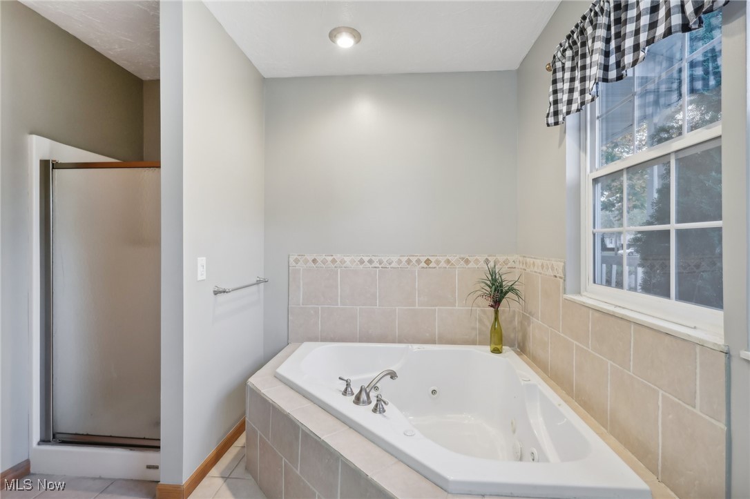 167 Birch Road Painesville, OH 44077 - Photo 30 of 49 Bathroom with tile patterned flooring and shower with separate bathtub