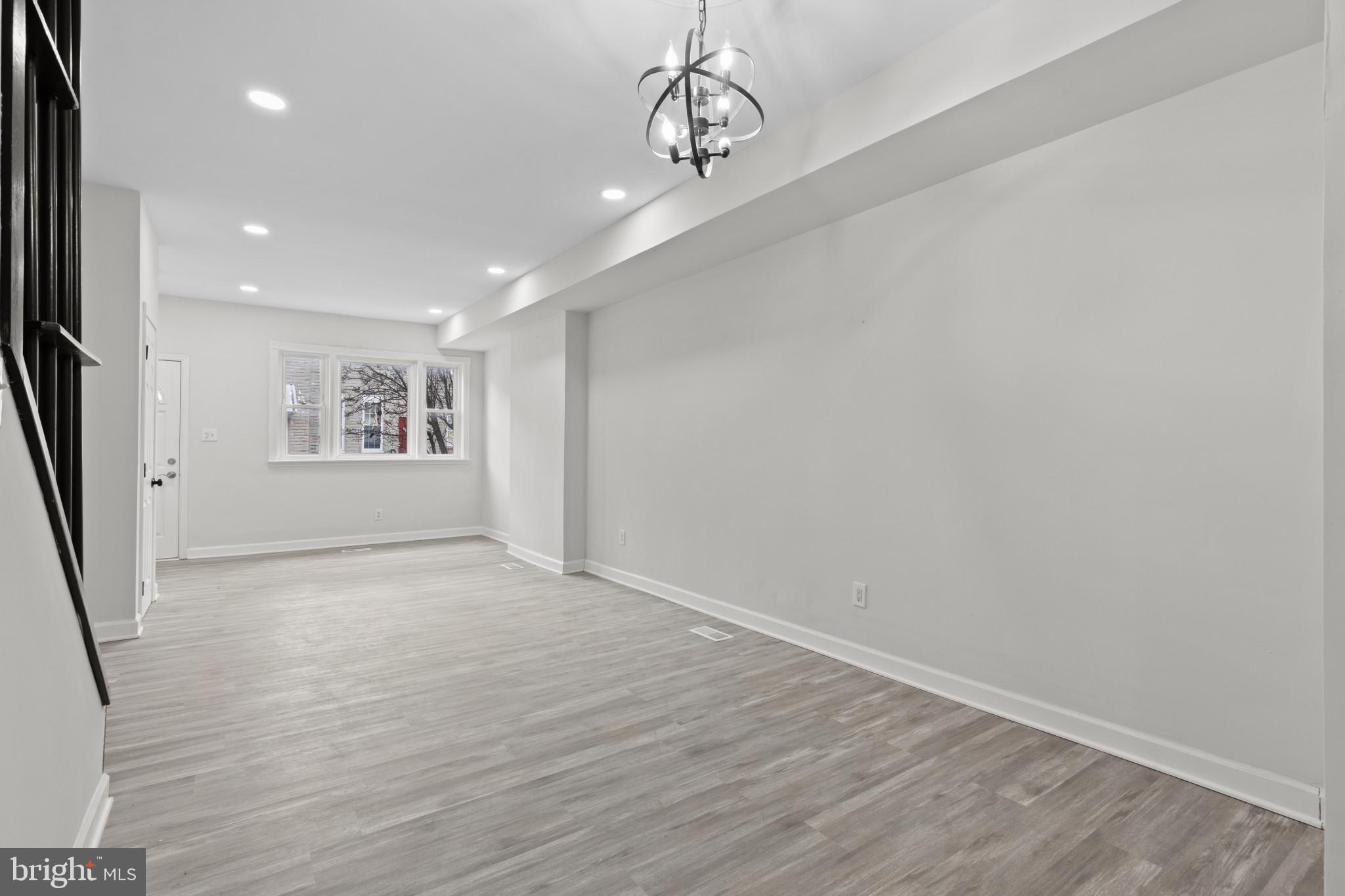 3404 East Pratt Street Baltimore, MD 21224 - Photo 11 of 39 a view of an empty room with a window and wooden floor