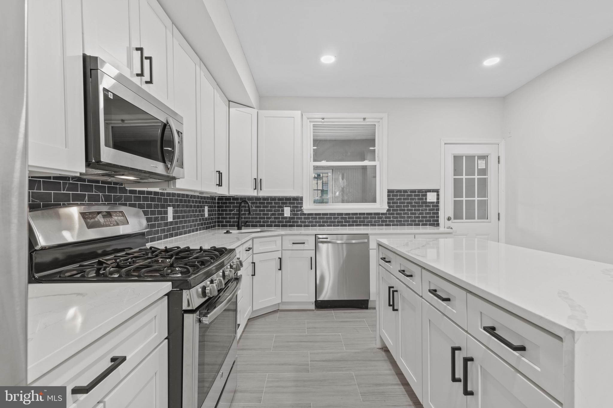 3404 East Pratt Street Baltimore, MD 21224 - Photo 13 of 39 a kitchen that has a sink and a stove top oven