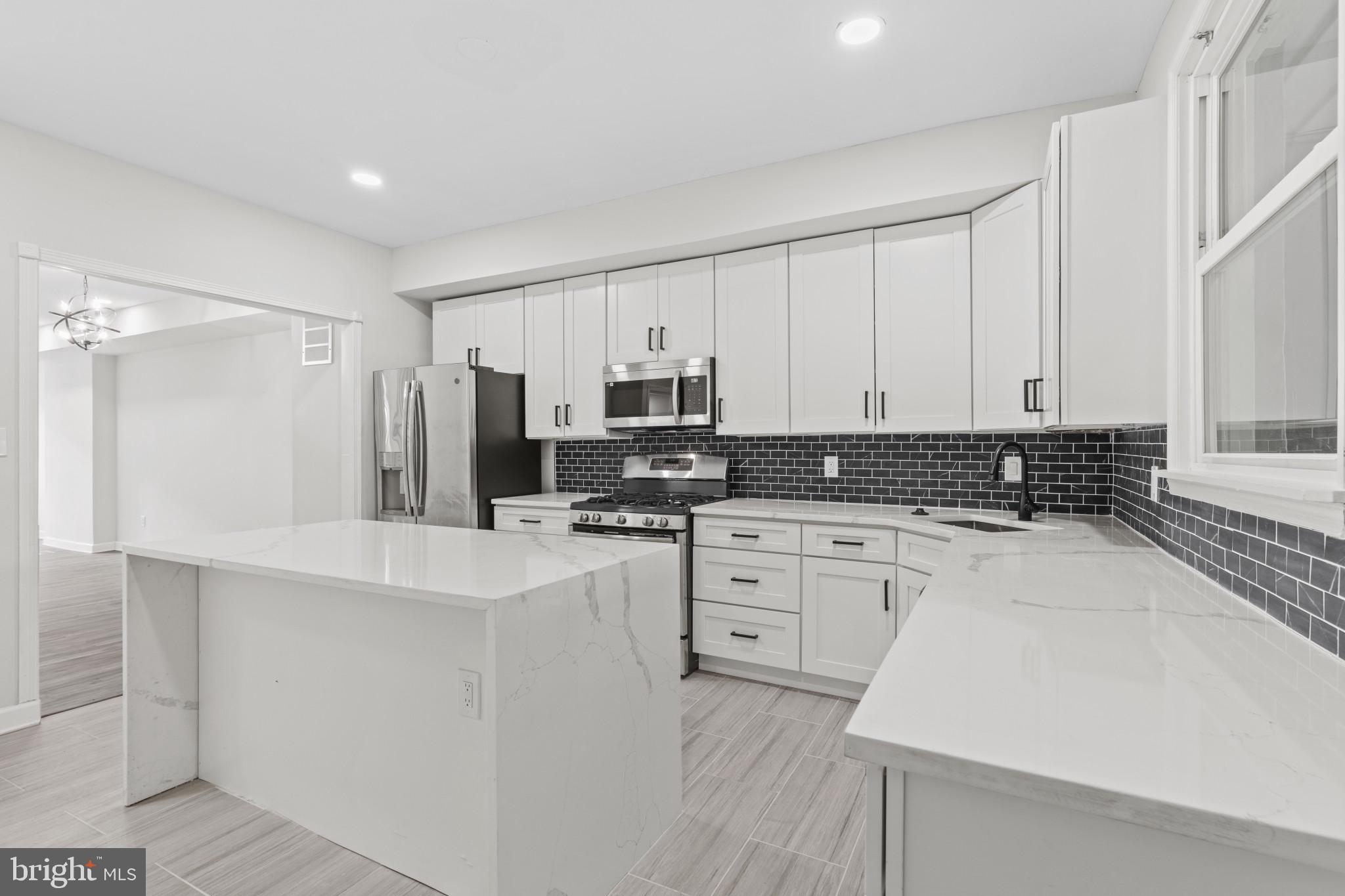 3404 East Pratt Street Baltimore, MD 21224 - Photo 15 of 39 a kitchen with stainless steel appliances a refrigerator sink and cabinets