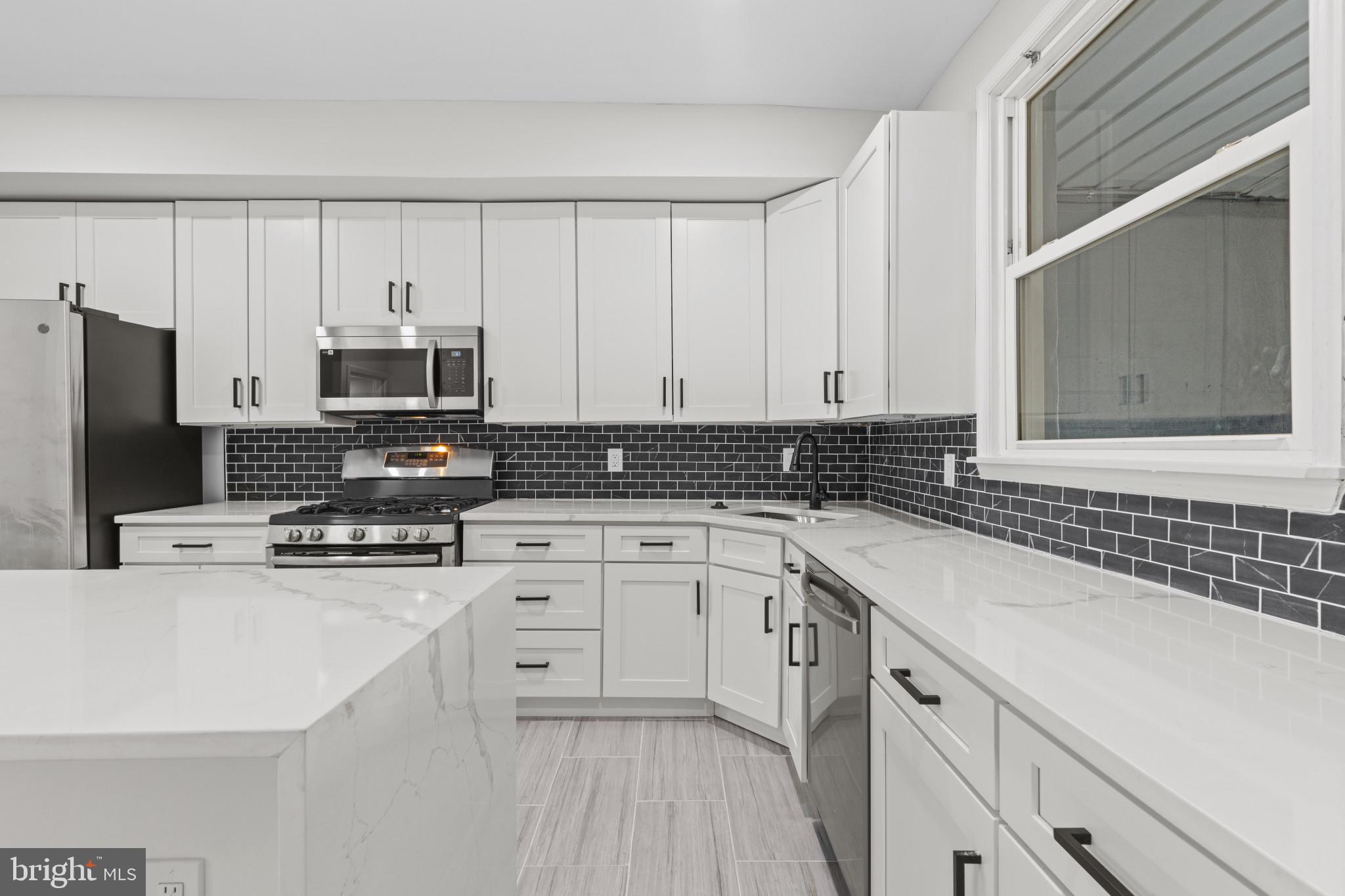 3404 East Pratt Street Baltimore, MD 21224 - Photo 16 of 39 a kitchen with cabinets appliances a sink and a counter top space