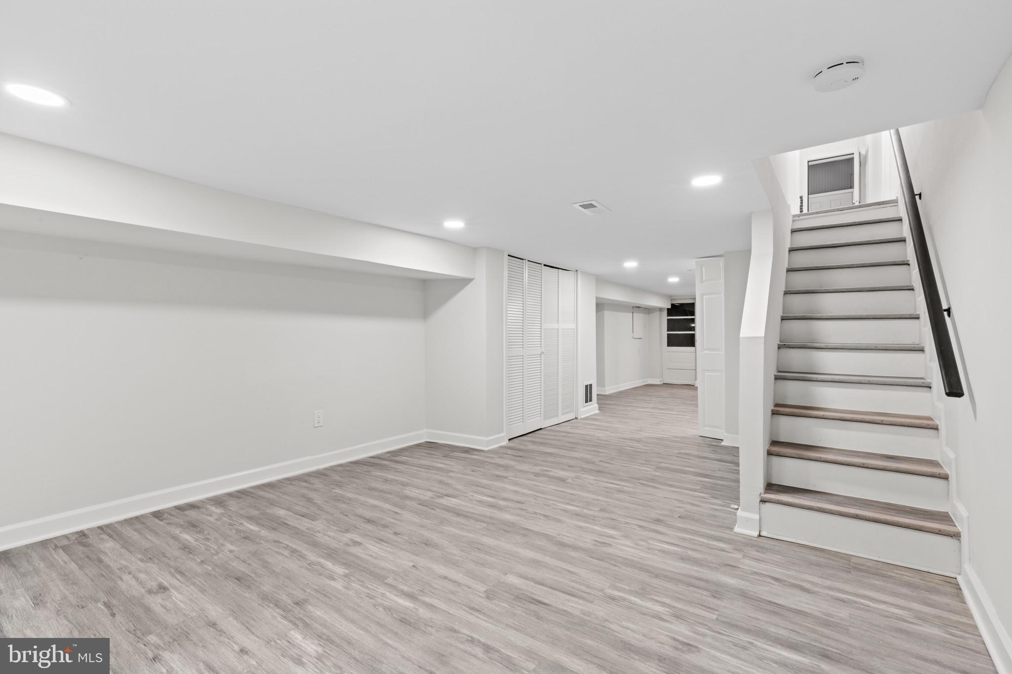 3404 East Pratt Street Baltimore, MD 21224 - Photo 20 of 39 a view of an empty room with wooden floor and stairs