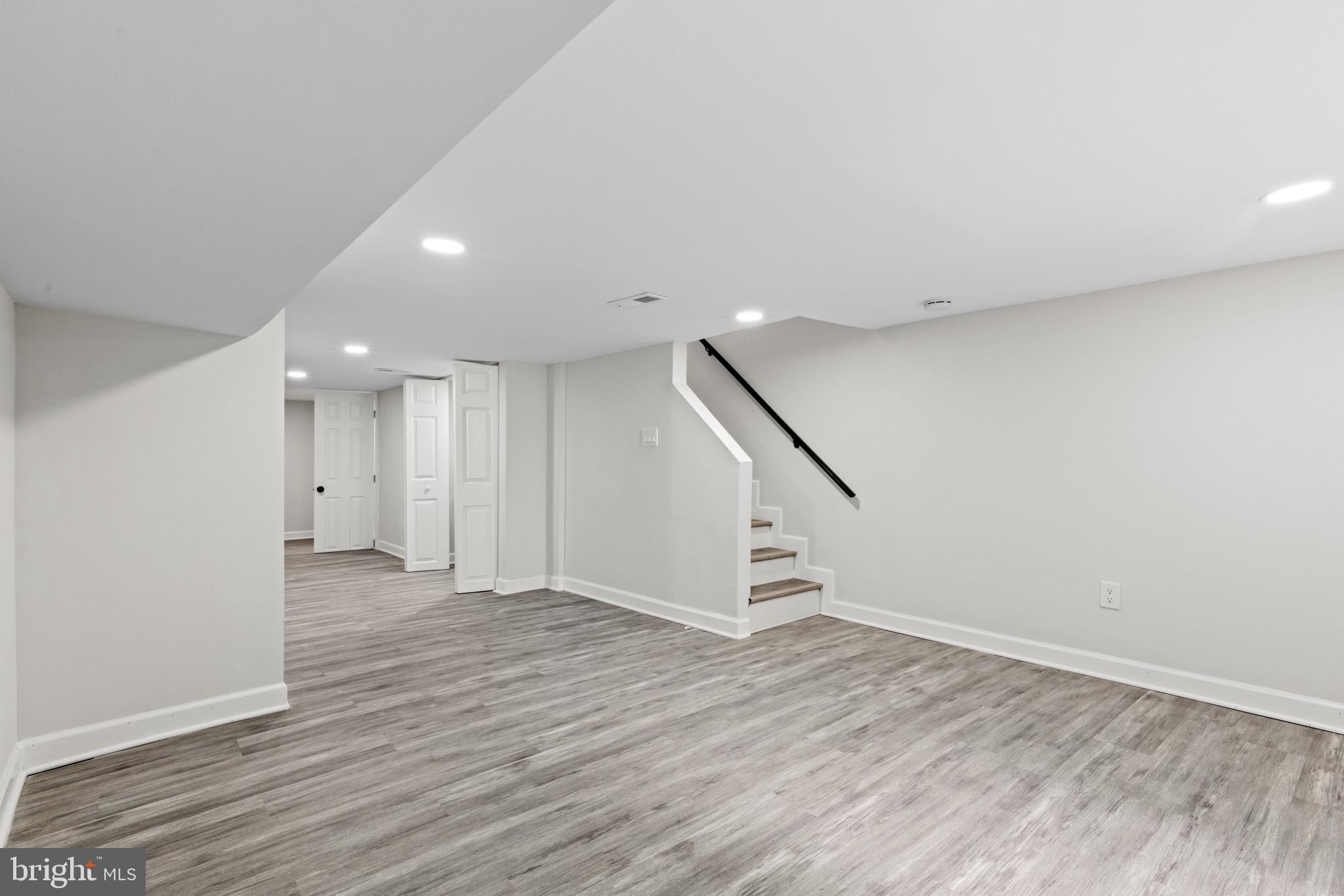 3404 East Pratt Street Baltimore, MD 21224 - Photo 21 of 39 a view of an empty room with wooden floor and stairs