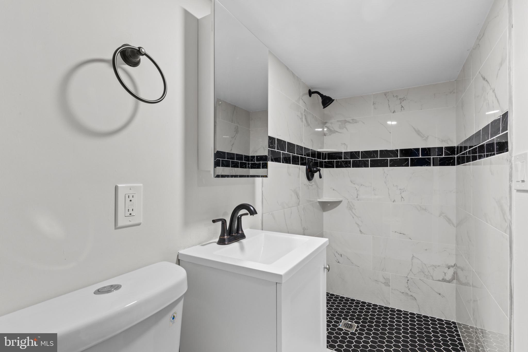 3404 East Pratt Street Baltimore, MD 21224 - Photo 26 of 39 a bathroom with a sink a toilet and a shower