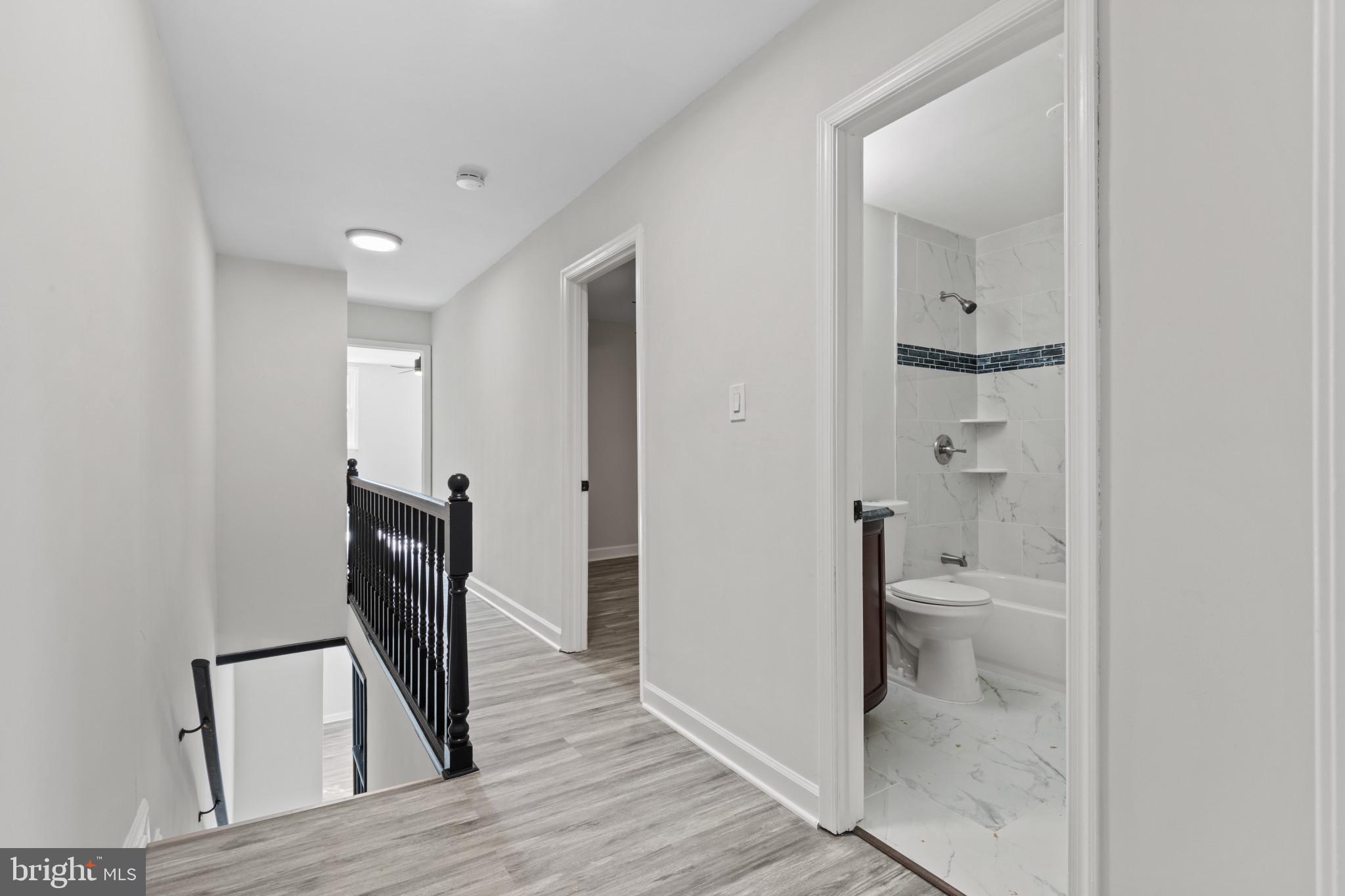 3404 East Pratt Street Baltimore, MD 21224 - Photo 28 of 39 a bathroom with a toilet a sink and a mirror