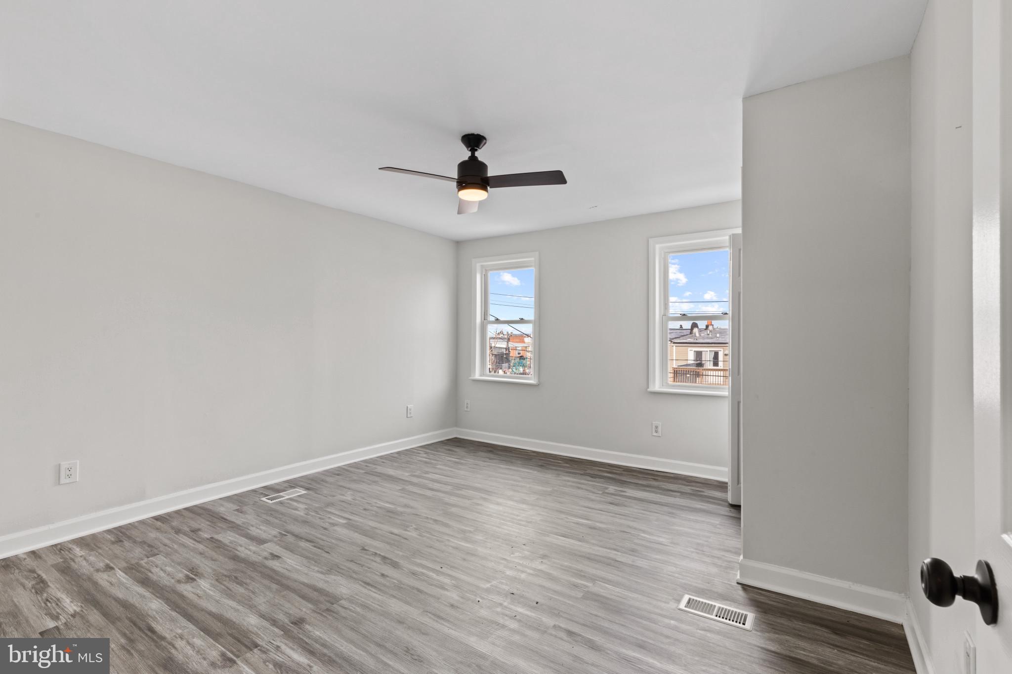 3404 East Pratt Street Baltimore, MD 21224 - Photo 30 of 39 a view of an empty room with a window and wooden floor