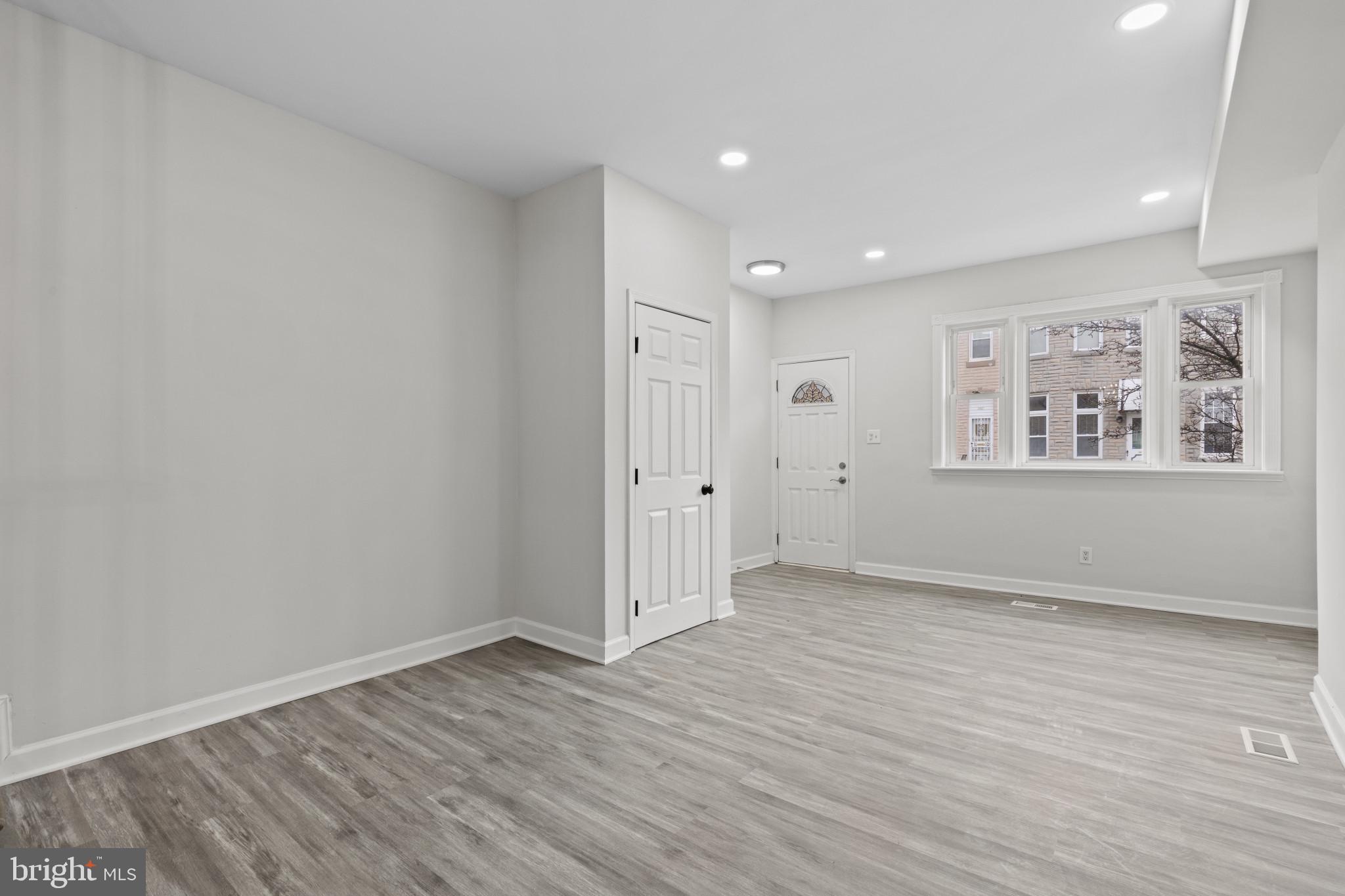3404 East Pratt Street Baltimore, MD 21224 - Photo 3 of 39 a view of empty room with wooden floor and window