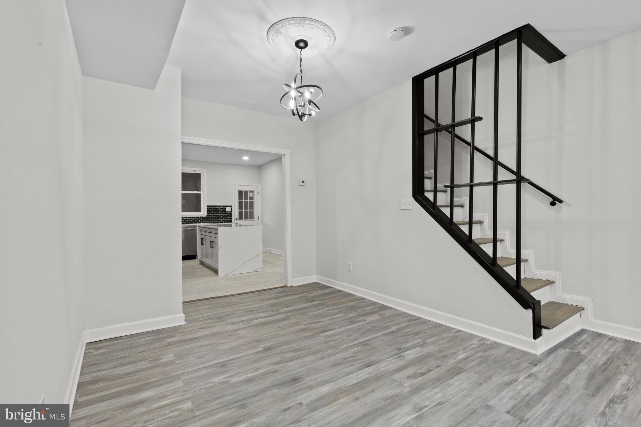 3404 East Pratt Street Baltimore, MD 21224 - Photo 9 of 39 a view of a hallway with wooden floor and staircase