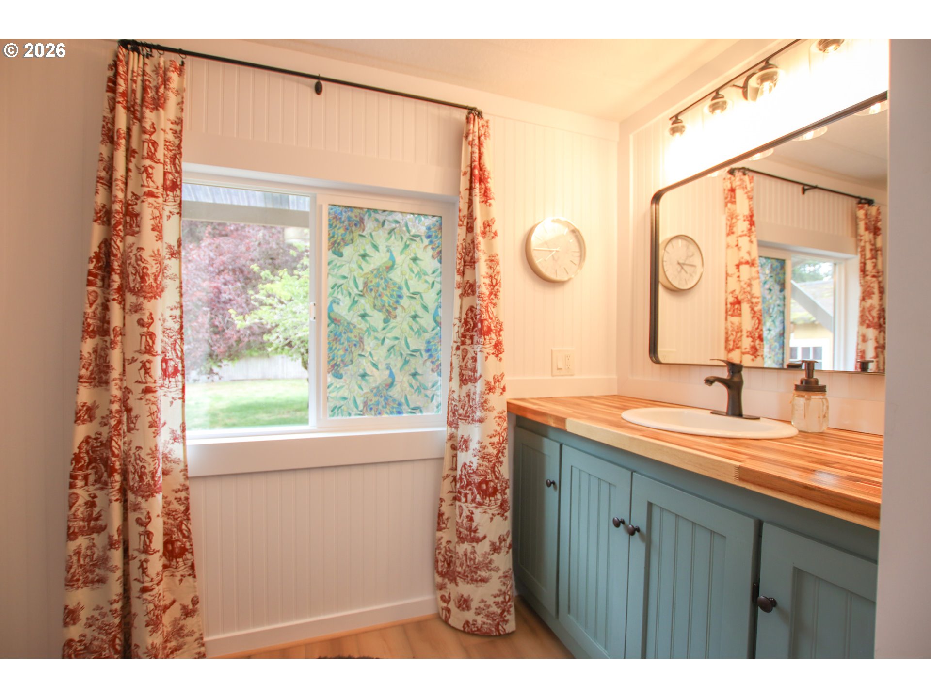 1431 Maple Street Florence, OR 97439 - Photo 34 of 43 a bathroom with a double vanity sink and mirror