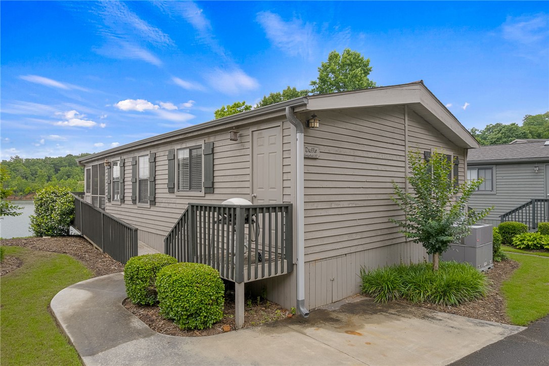 1230 Melton Road, Unit 25 West Union, SC 29696 - Photo 41 of 46 A quaint waterfront dwelling boasts a screened porch and a convenient outdoor deck.